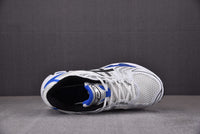 Asics Gel-Kayano 14 White with Black and Blue Accents.