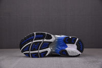 Asics Gel-Kayano 14 White with Black and Blue Accents.
