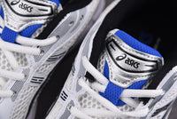 Asics Gel-Kayano 14 White with Black and Blue Accents.