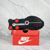 Nike Shox R4 White/Blue with Red Accents.