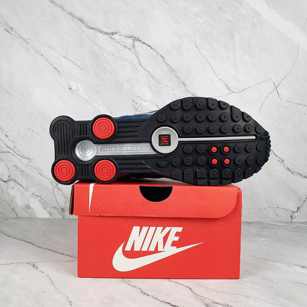 Nike Shox R4 White/Blue with Red Accents.