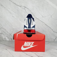 Nike Shox R4 White/Blue with Red Accents.